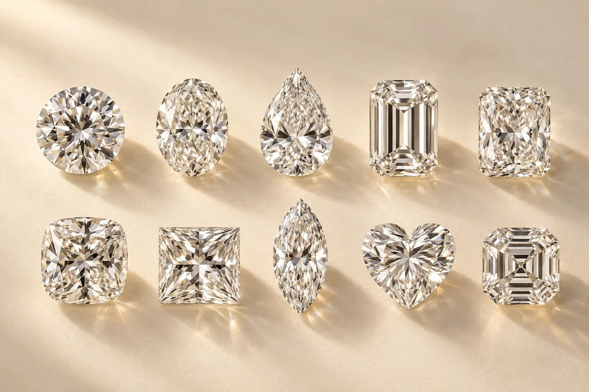 Loose diamonds in different shapes — round, oval, pear, heart, marquise, emerald and princess — on a black surface