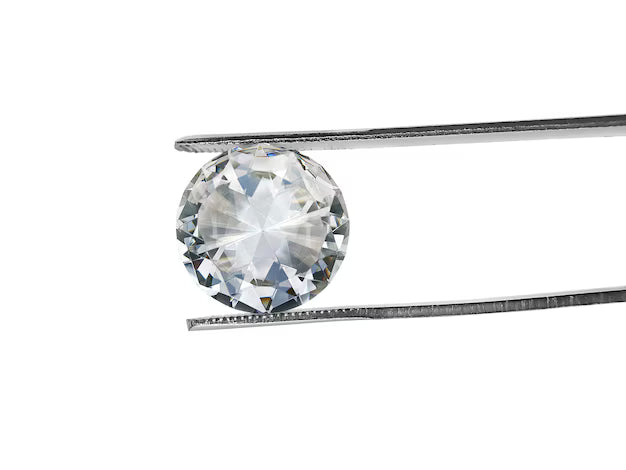 Round brilliant diamond held in tweezers